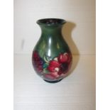 An initialled pinch necked ovoid Moorcroft vase decorated with anemone on green ground, W.A.