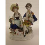 Porcelain figural group of man and woman with bagpipes and lamb on a stone seat, the edge of the