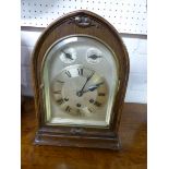 An Edwardian oak dome shaped striking mantle clock with subsidiary slow / fast and silent / chime