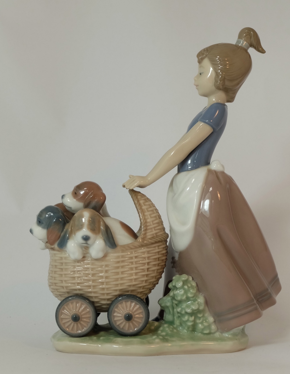 Lladro figure Girl pushing pram full of puppies, height 22cm