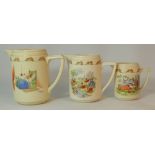 Royal Doulton early Bunnykins graduated set of Jugs, in bed spider, in bed birds and playing by the