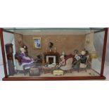 Display cased dolls room complete with dolls and furniture