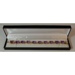 Gold and amethyst bracelet, 15ct or higher unmarked gold bracelet set with 10 amethyst stones,