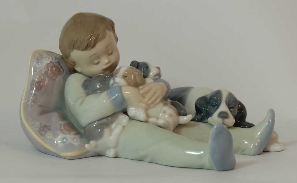 Lladro figure Boy lying with dog, length 18cm