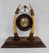 A late victorian mahogany & Brass and ivory mantle clock, pair tusks supporting round mahogany