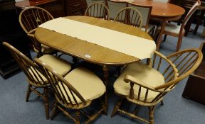 Modern Oak dinning table with six windsor style chairs including two carvers
