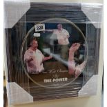 A commemorative plaque Phil the power Taylor thirteen times world champion in wood frame