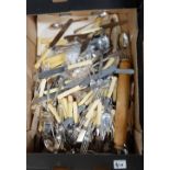 A large collection of vintage cutlery including fish knives, serving spoons,