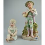 Continental unmarked Bisque figures of Peasant boy playing Mandolin (damaged neck) and Piano baby