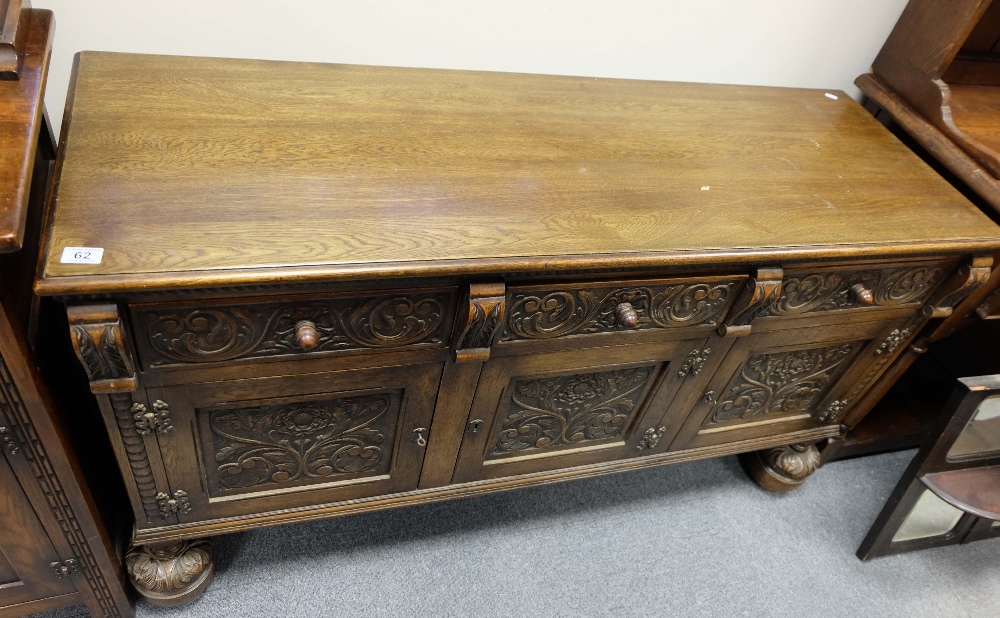 Carved oak three door sideboard