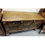 Carved oak three door sideboard