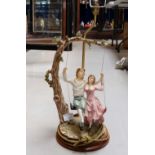 Large Capo de Monte style lamp base in the shade of young lovers on a tree swing