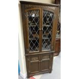 reproduction Carved oak corner cupboard with glazed doors