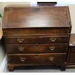 Georgian oak Bureau having bracket feet and sliding well and fitted interior,