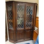 Reproduction large oak linen fold sectional bookcase comprising of four central doors with corner