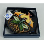 Moorcroft pin dish dated 2011 12cm diameter decorated Art Nouveau flower on black ground