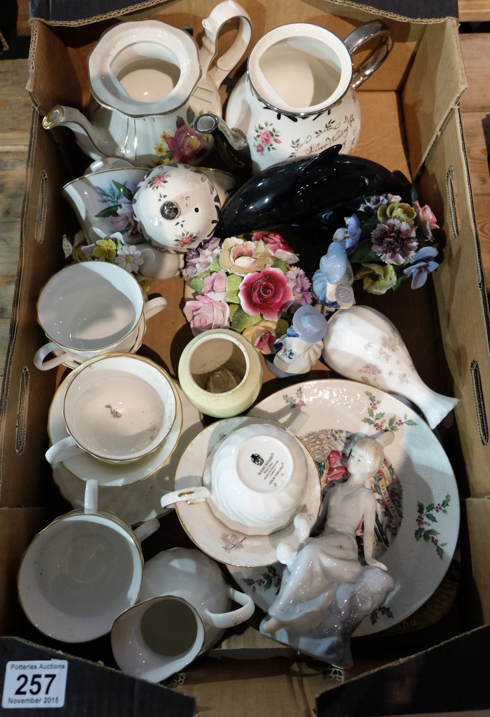 A collection of pottery to include Wedgwood gold chelsea, Poole dolphin model,