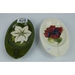 Moorcroft oval ashtray decorated in the hibiscus design (chip to underside) and similar decorated