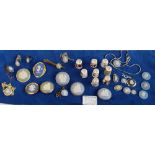 A good collection of Wedgwood jasper ware jewellery and miniatures in various colours to include