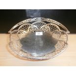 Circular pierced silver basket with swing handle