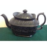 A Wedgwood basaltware teapot of silver shape with domed lid having pointed finial framed by border