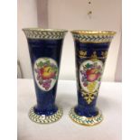 A pair of Maling trumpet vases decorated with panels of fruit on blue ground, framed by leaf &