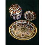 Three pieces of Royal Crown Derby decorated in the traditional Imari palette - a ginger jar & cover,