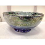 A Maling Chelsea bowl decorated with parrots in scalloped cartouche panels on green fishscale