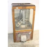 1950s Amusement Arcade Grab machine in an oak framed case with glazed side panels and mirrored back,