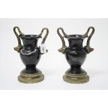 Pair black marble urns with gilt metal mounts in the form of boars' heads,