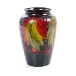 Moorcroft pottery Flambé vase decorated in the leaf and berry pattern, blue painted signature and