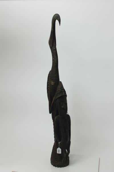 African carved wood fertility figure of a woman and a bird,