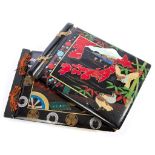 Two large Japanese black lacquer albums with painted decoration and tied with tassels,