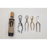 Four pairs of champagne tongs and a turned wood wine corker (5)