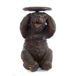 Late 19th century Black Forest carved wooden piano stool in the form of a seated bear, with