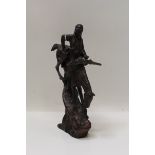 Bronze figure of a Native American on horseback, riding down a steep slope,