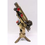 Early 20th century brass microscope on tripod foot