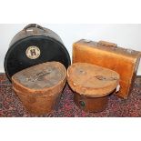 Two Victorian vintage leather hat boxes with top hats,