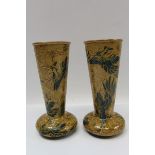 Pair of Doulton Lambeth vases with painted bird decoration on brown ground, impressed factory