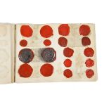 Scrapbook containing a collection of 19th century wax seal impressions of coinage from the 12th -