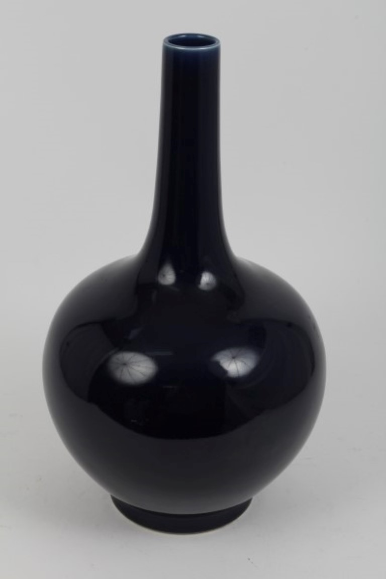 Chinese blue glazed bottle vase raised on circular foot - six character mark to base, 40.5cm