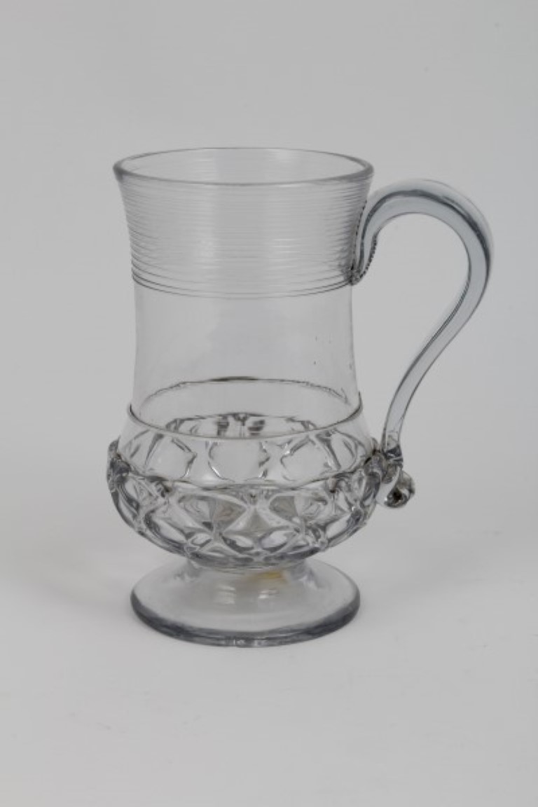 Georgian glass baluster-shaped mug with trailed and moulded decoration, the base inset with a George