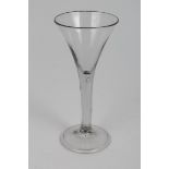 Georgian wine glass with trumpet-shaped bowl, plain stem with air drop on splayed folded foot,