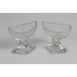 Pair George IV cut glass boat-shaped salts on diamond-shaped stepped bases