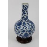 Antique Chinese blue and white bottle vase with painted floral decoration and underglazed blue