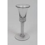 Georgian wine glass with waisted trumpet-shaped bowl with arranged bubbles in shoulder on opaque