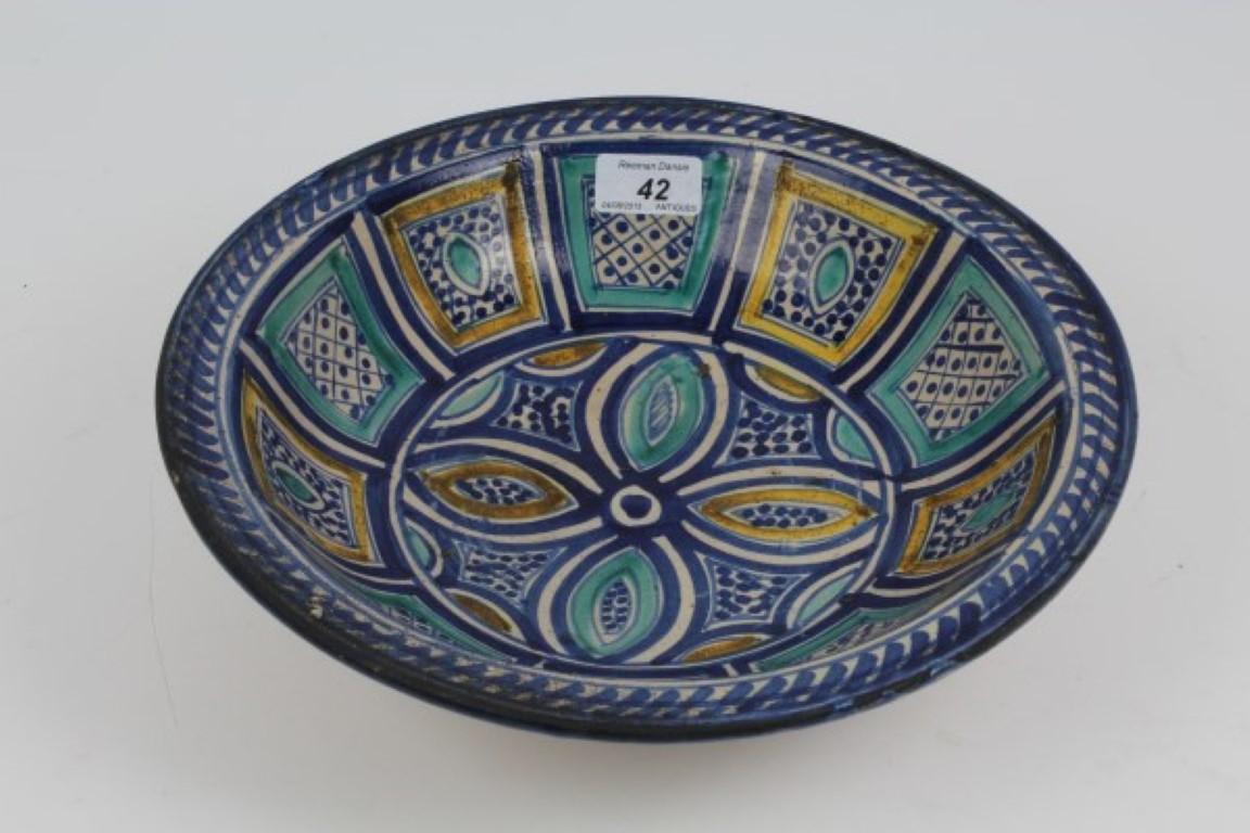 Antique Spanish pottery dish with tin glazed geometric and stylised floral decoration on raised