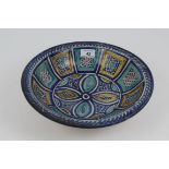 Antique Spanish pottery dish with tin glazed geometric and stylised floral decoration on raised