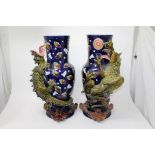 Pair of impressive late 19th century Majolica vases with climbing dragon,