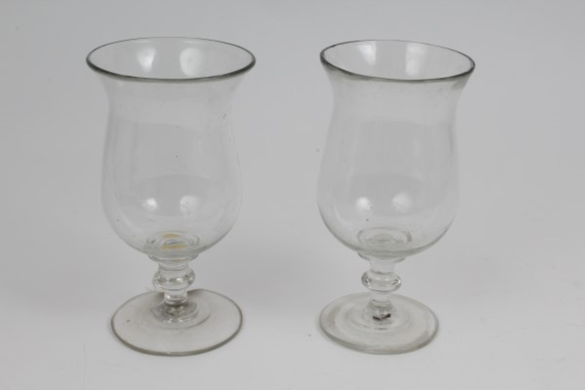 Pair Georgian glass storm lamps with baluster bowls on knopped stems on splayed foot, 18.